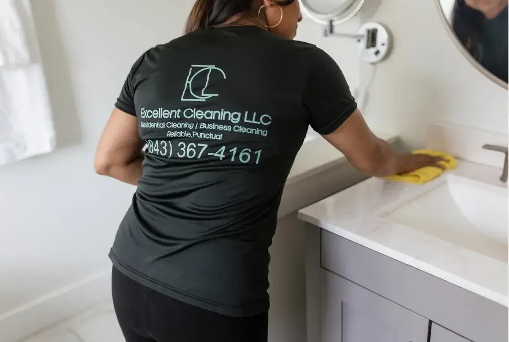Professional cleaner wiping countertop during detailed home cleaning service